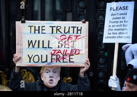 Londra, Regno Unito. 22 Febbraio 2020. Una persona indossa una maschera di Donald Trump che porta un cartello fuori dalla Casa australiana di Aldwych prima di una marcia a Piazza del Parlamento a sostegno del fondatore di Wikileaks Julian Assange. Il processo di estradizione completo del sig. Assange inizia a Londra il 24 febbraio. Credito: Stephen Chung / Alamy Live News Foto Stock