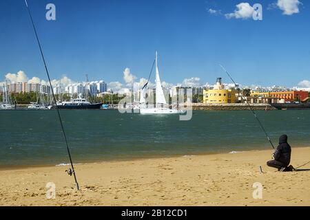 Vista da Ferragudo con pescatori per la marina di Portimão, Ferragudo, Faro, Algarve, PORTOGALLO Foto Stock