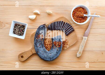 Fette tagliate di salsiccia speciale a ferro di cavallo Pirot - Peglana Pirotska kobasica, a base di carne di vitello, pecora e capra, con aggiunta di aglio Foto Stock