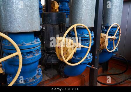 Valvola con timone giallo sulla tubazione. Foto Stock