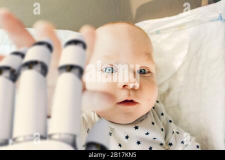 Ritratto di bambino ragazzo che raggiunge per mano robot Foto Stock