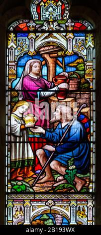 Vetrate West window dettaglio atti di Misericordia, 1878, Grande chiesa di Bealings, Suffolk, Inghilterra, UK di H Hughes Foto Stock