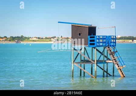Tipica vecchia capanna di pesca in legno su palafitte nell'oceano atlantico vicino a la Rochelle, Francia Foto Stock