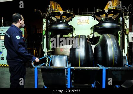 Un lavoratore cinese produce pneumatici in gomma presso lo stabilimento di Sailun Group Co., Ltd. A Qingdao City, provincia cinese orientale Shandong il febbraio 24th, 20 Foto Stock