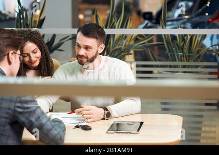 giovane uomo e sua donna che discutono di processo di acquisto. manager che lavora con i clienti al bar. incontro con i clienti. business Foto Stock