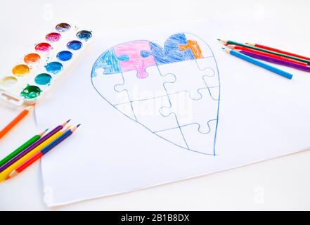 Coloratissimo cuore disegnato da un bambino con puzzle sullo sfondo bianco come simbolo dell'autismo, con matite colorate e acquerelli. Foto Stock