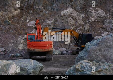 Due escavatori che scavano insieme il terreno Foto Stock