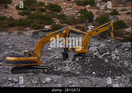 Due escavatori che scavano insieme il terreno Foto Stock