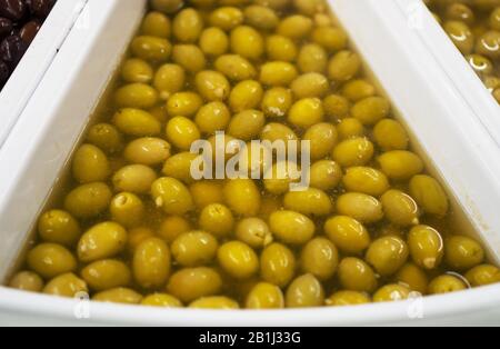 Olive verdi in salamoia in supermercato. Foto Stock