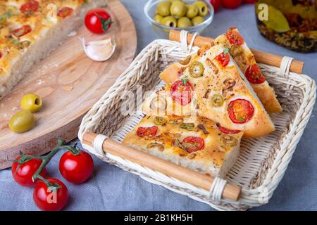 Focaccia con pomodori e olive. Pane italiano tradizionale. Cottura fatta in casa. Primo piano, messa a fuoco selettiva. Foto Stock
