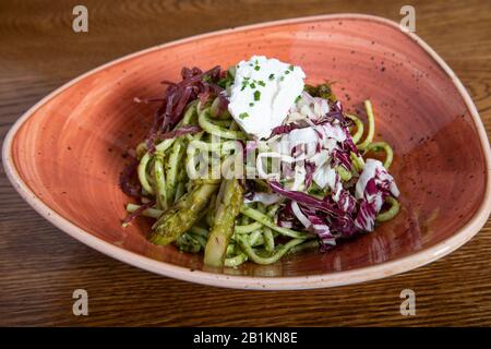 Delizioso piatto di pasta. Pesto linguino con bresaola, julienne radicchio e ricotta. Cucina tipica mediterranea Foto Stock