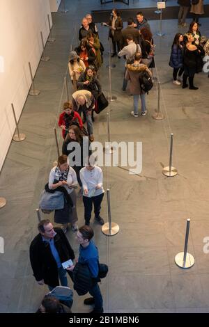 Visitatori In Attesa in linea a Coat Check, MoMA, NYC , USA Foto Stock