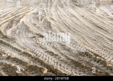Pneumatici su terreno sabbioso in cantiere. Foto di scorta gratuita. Foto Stock