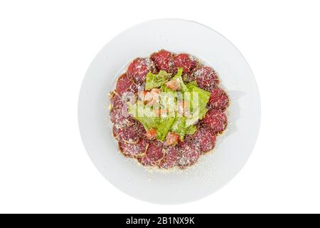 Antipasto freddo prima dell'alcol, arrosto di manzo marinato, fritto, manzo, con pomodoro, lattuga e formaggio grattugiato su piatto, vista sfondo bianco isolato Foto Stock