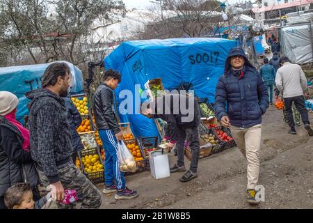 Lesbo, Grecia. 27th Feb, 2020. Un migrante acquista frutta e verdura in uno stand in un campo di tenda temporaneo vicino al campo per i migranti a Moria. A seguito di gravi scontri tra polizia e abitanti arrabbiati dell'isola greca di Lesbo, che ha lasciato decine di feriti, il primo ministro Mitsotakis ha ordinato alla polizia antisommossa di ritirarsi dalle isole. Credito: Angelos Tzortzinis/Dpa/Dpa/Alamy Live News Foto Stock