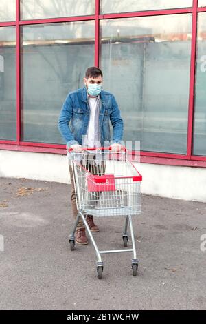 Nessun problema alimentare, panico acquistare cibo. Acquisti nel timore di coronavirus, virus, infezione, epidemia, pandemic.Man in maschera protettiva medica con vuoto Foto Stock