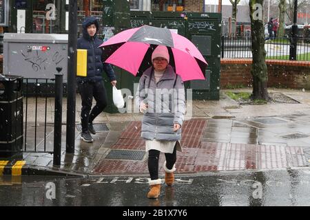 Londra, Regno Unito. 27th Feb, 2020. Una donna è vista sotto un ombrello come la neve cade nel nord di Londra. Credit: Sopa Images Limited/Alamy Live News Foto Stock