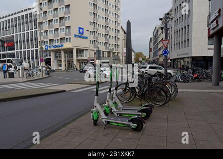 Una fila di scooter elettrici a noleggio senza dockless Lime S parcheggiati accanto a un portabiciclette nel centro di Colonia, in Germania Foto Stock