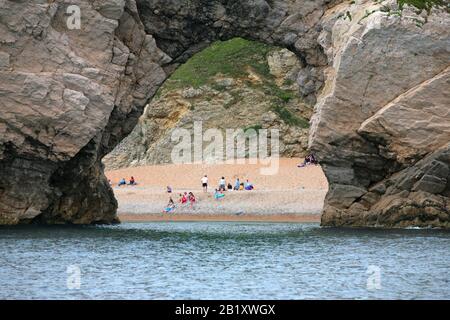 Guardando attraverso Durdle Door dal Seaward, in una giornata tranquilla, Dorset, Inghilterra, Regno Unito: Parte del sito Patrimonio Mondiale dell'UNESCO Dorset e East Devon Coast Foto Stock