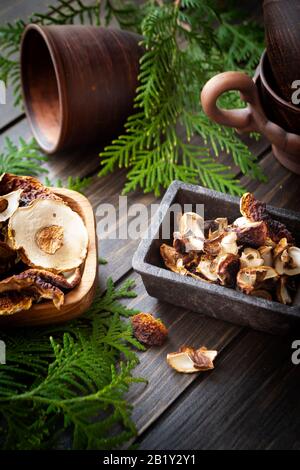 Funghi secchi in ciotole di legno. Funghi porcini sul vecchio sfondo di legno in stile rustico. Foto Stock