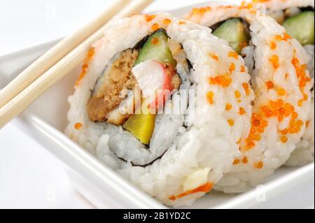 Futomaki (sushi roll) bacchette su sfondo bianco Foto Stock