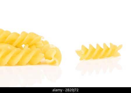 Molta pasta gialla intera fusilli isolata su fondo bianco Foto Stock