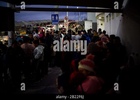 Ciudad Juarez, Chihuahua, Messico. 28th Feb, 2020. I richiedenti asilo si riuniscono ai piedi del porto di entrata Paso del Norte a Ciudad Juarez, Chihuahua, Messico. Un tribunale federale d'appello ha ripristinato un blocco sui protocolli di protezione dei migranti dell'amministrazione Trump, noti anche come "Rimanere in Messico", la politica d'immigrazione il 28th febbraio ed è stato successivamente revocato dopo alcune ore, consentendo il ripristino della politica. Credito: Joel Angel Juarez/Zuma Wire/Alamy Live News Foto Stock