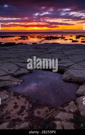 Il cielo si schiarisce dopo una tempesta di pioggia appena abbastanza a lungo per mostrare le profonde nuvole rosse e viola sulla costa sud del dorset jurassic Foto Stock