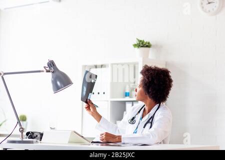 Medico afro americano nel suo ufficio in ospedale Foto Stock