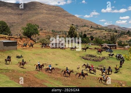 Uomini che arrivano a cavallo ad una cerimonia di iniziazione vicino a Pitseng (Leribe), Lesotho Foto Stock