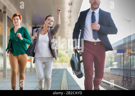 Ritratto di uomini d'affari che corrono per prendere il treno in stazione Foto Stock