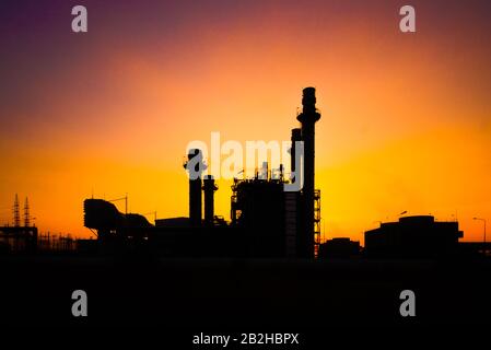 Luce di bagliore dell'industria petrolchimica sul tramonto e il cielo crepuscolo, centrale elettrica, area della centrale elettrica di energia Foto Stock