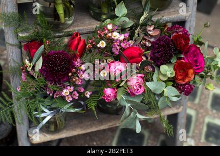 Una varietà di colori vicino al negozio Liberty di Londra. Grandi bouquet in vasi di stagno. Piccoli bouquet per diverse occasioni Foto Stock