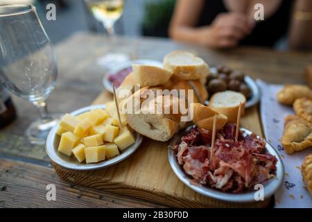 Selezione di salumi con salumi, formaggi, olive e bevande Foto Stock