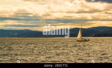 Fiume Saguenay, Canada - 18 agosto 2019: Barca a vela sulla Valle del fiume Sagueney al tramonto Foto Stock