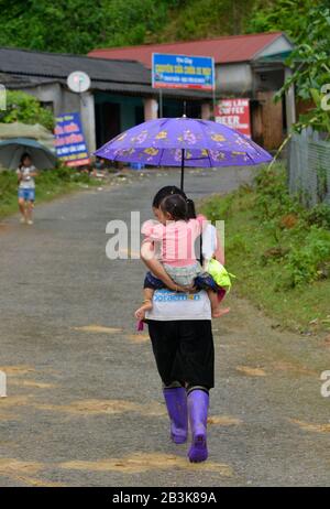Mutter, Gentile, Regenschirm, Tha Pin, Vietnam Foto Stock