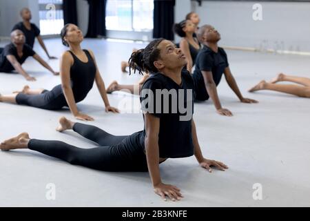 Ballerini moderni di razza mista che si allungano in uno studio Foto Stock