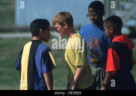 Austin, Texas USA, circa 1995: Ragazzi giovani che discutono sul parco giochi della scuola. ©Bob Daemmrich Foto Stock