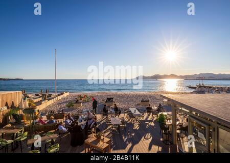 Francia, Alpes-Maritimes, Cannes, la spiaggia privata di Vegaluna dal lungomare della Croisette, il Golfo di Napoule e l'Esterel sullo sfondo Foto Stock