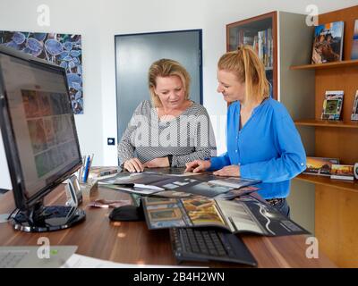 Due colleghi discutono del nuovo materiale pubblicitario Foto Stock