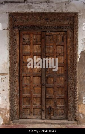 Destinazione Tanzania, Isola di Zanzibar: Impressioni da Stone Town, il più antico distretto di Zanzibar, la capitale dello stato tanzaniano di Zanzibar. Porta in legno. Foto Stock