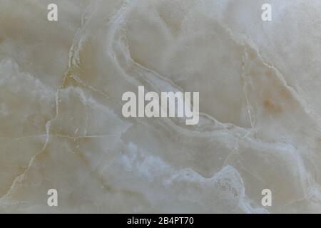 Marmo beige naturale lucido con linee diagonali ondulate. Foto Stock