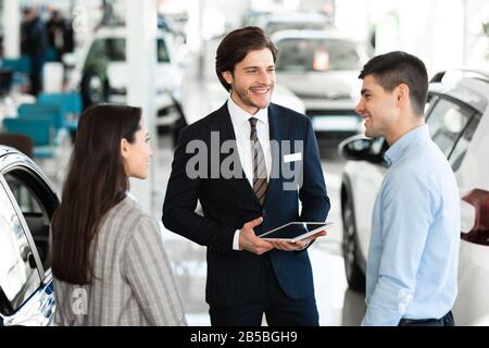 Concessionario Auto Vendita Auto A Giovane Coppia Foto Stock