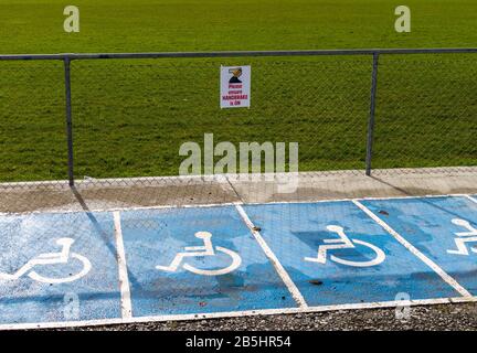 Inserire l'indicazione del freno a mano nell'area di parcheggio per disabili. Foto Stock