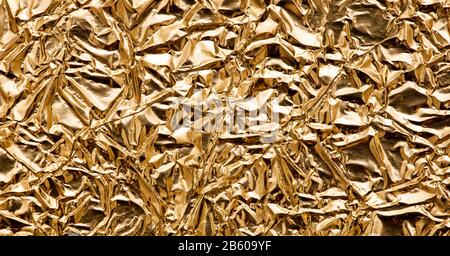Oro carta metallizzata rugosa lucida sfondo astratto, banner web Foto Stock