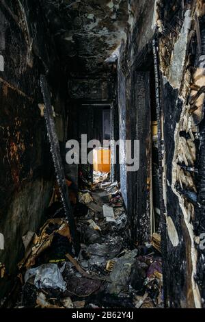 Corridoio di casa di legno bruciato scuro dopo il fuoco. Foto Stock