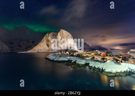 Bellissima Aurora Boreale Ad Hamnoy, Isola Lofoten In Norvegia. Aurora Boreal sopra il piccolo villaggio di pescatori con le sue tradizionali capanne rosse. Maestoso gr Foto Stock