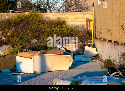 Un paesaggio rurale in campagna con terreno sporco vicolo, prato verde erba natura e abbandonato edificio in background. Foto Stock