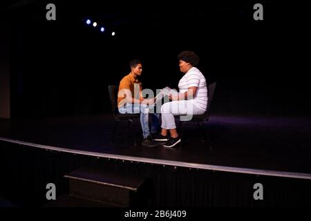 Vista laterale degli studenti che praticano in un teatro Foto Stock