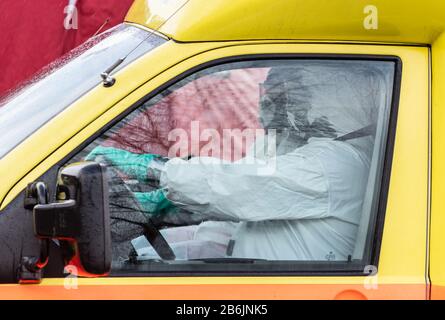11 marzo 2020, Repubblica Ceca, Usti Nad Labem: I dipendenti del servizio di ambulanza ceco trasportano le persone in un'ambulanza dopo aver controllato i viaggiatori in una stazione di servizio sull'autostrada D8 Dresden - Praga. Per evitare la diffusione del virus corona, la Repubblica ceca ha avviato controlli casuali di viaggiatori ai confini con la Germania e l'Austria. Foto: Robert Michael/dpa-Zentralbild/dpa Foto Stock